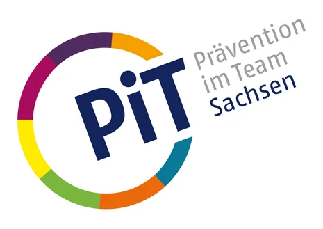 Links ist ein Kreis mit bunten Umrissen. An einer Stelle ist dieser unterbrochen und dort steht "PiT". Neben dem Kreis steht zudem "Prävention im Team" in grauer Schrift und darunter "Sachsen" in blauer Schrift.